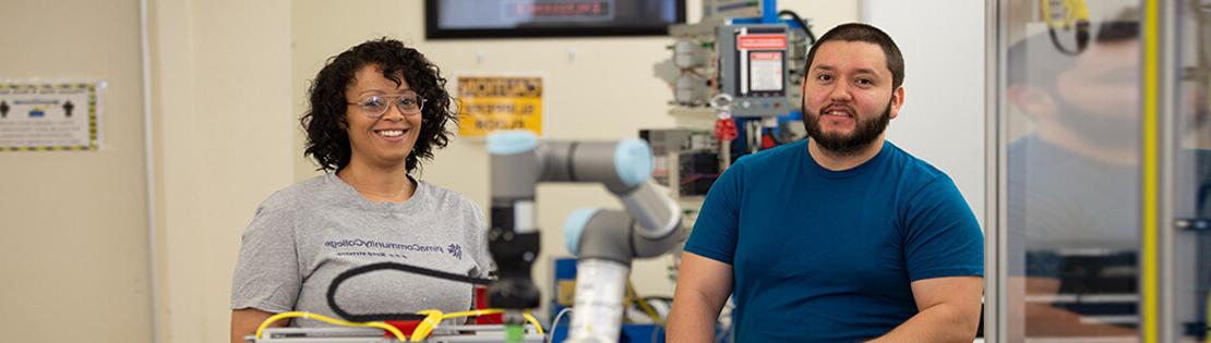 two students work on engineering equipment in a Pima Lab